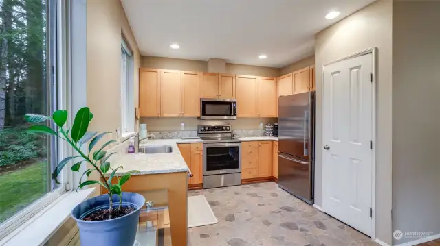 The kitchen has an eating nook and a door to the deck which is perfect for morning coffee or enjoying the tranquil outdoors.