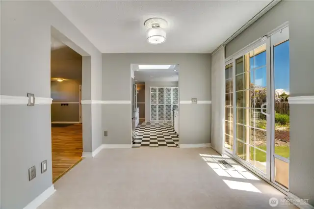 Family room with sliding door to backyard. Views into the kitchen.
