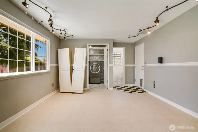 Family room viewing into laundry room and 1/2 bath. Door to the right accesses garage.
