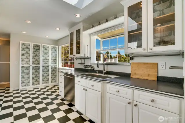 Updated kitchen; white cabinets, countertops, built-ins and separate closet pantry. Small eating nook looks to backyard.