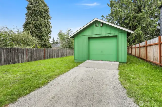 The garage has shop space and entry off the alley.