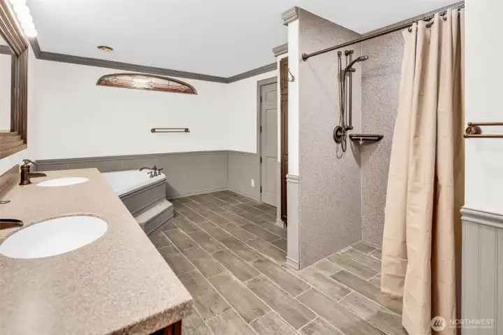 Accessible walk-in shower with dual heads and fold-down chair (not seen)