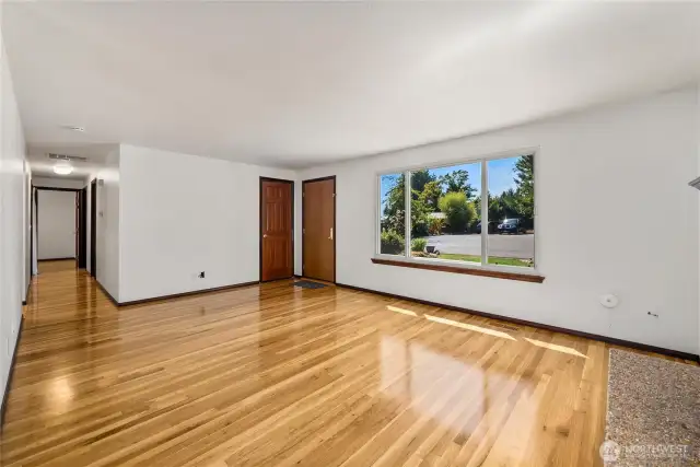 From this angle, you’ll notice the seamless open flow to the hallway and bedrooms. Large, upgraded windows not only brighten the space but also deliver superior noise cancellation—a huge benefit in the heart of Des Moines.