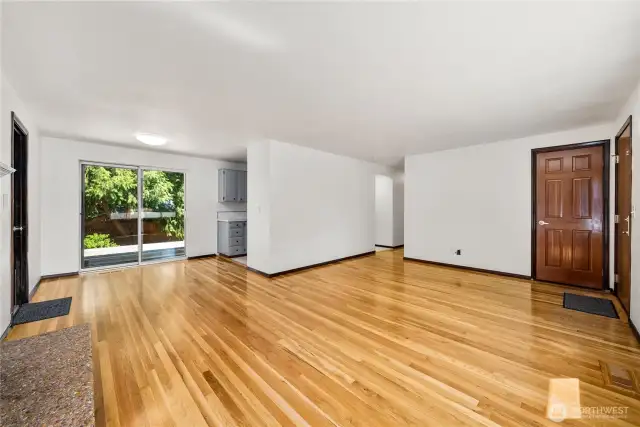 Open-concept living with beautifully restored hardwood floors and sliding glass doors leading to the backyard. The versatile layout connects living, dining, and kitchen, while the energy-efficient quadruple-pane windows keep the home peaceful and insulated year-round.