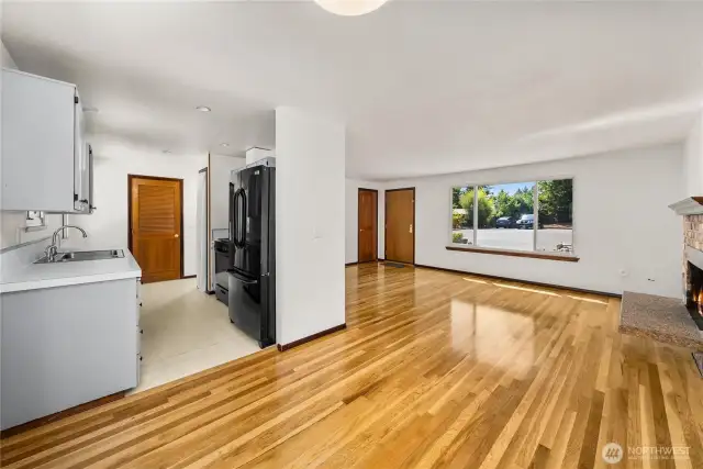 Open dining space that flows effortlessly into both the updated kitchen and the living room. Featuring durable hardwoods, neutral paint, and sightlines to the front yard through quadruple-pane windows, this layout is ideal for everyday living and gatherings.