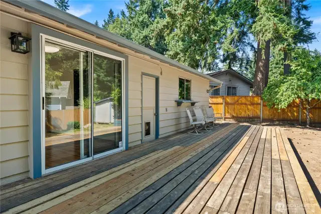 Sliding glass doors lead directly from the dining area to the expansive deck, blending indoor and outdoor living with ease.