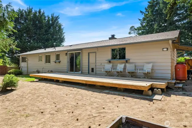 Another angle of the backyard shows the home’s deck space and easy-maintenance yard, ready for personalization.