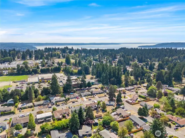 Just minutes from the new Light Rail station, SeaTac Airport, I-5, and halfway between Seattle & Tacoma — North Hill offers unbeatable convenience. The aerials also showcase the tree-lined community, nearby schools, and even views of Puget Sound in the distance.