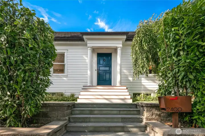 Framed by lush greenery, the stately entry welcomes you with elegant stairs and one-of-a-kind Corten steel mailbox. The custom-designed front door sets the tone for the thoughtful craftsmanship and authentic finishes that define this Montlake Grande Dame throughout.