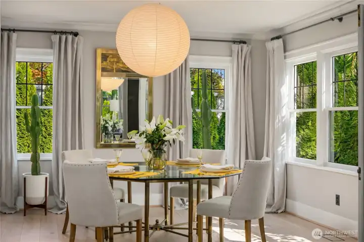 An authentic Noguchi pendant sets a sculptural tone above the dining space, while original wood windows frame leafy garden views, including the southern facing cherry tree.