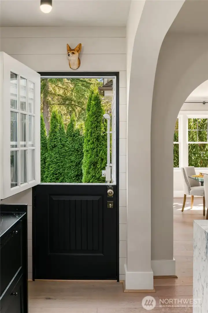 A custom Simpson solid wood Dutch door leads directly from the kitchen to the garden.