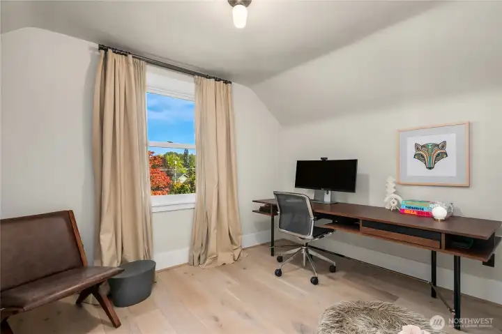 This upstairs bedroom offers flexibility for sleeping, study, or creative space.