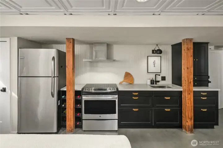 Designed for everyday living, this kitchen offers generous storage, a built-in wine rack, and modern lighting.
