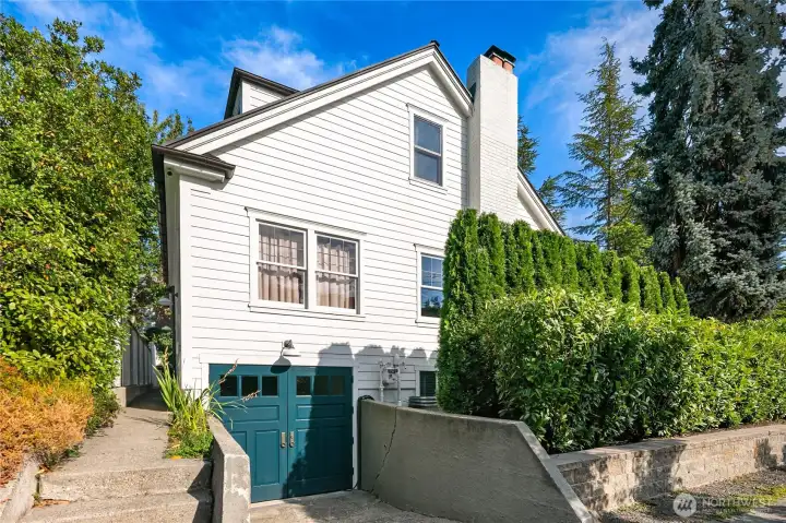 The west-side elevation showcases the custom-designed carriage doors at the garage, restored to their original height for architectural integrity. Inside, a Level 2 electric car charger provides modern convenience. Did we mention the Euroshield roof with a limited lifetime warranty?