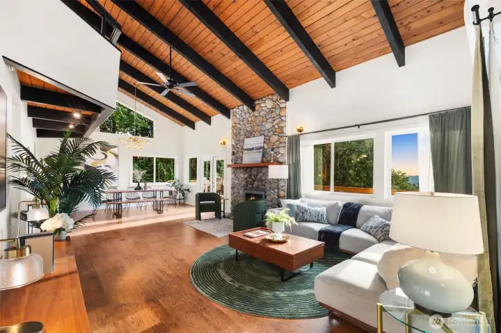 Living area straightaway, connected to a sitting area and dining.