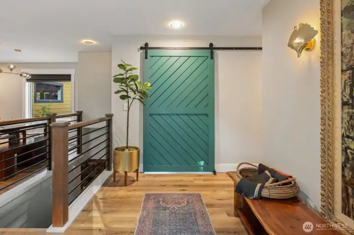 Entry faces barn door to laundry