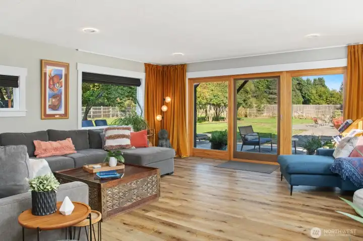Living room with patio doors to fenced part of yard.