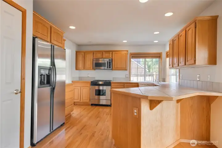 Walk through kitchen with stainless steel appliances.