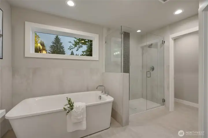 Immerse yourself in tranquility with a luxurious soaking tub, paired with a large, glass-enclosed shower — a harmonious blend of comfort and sophistication.
