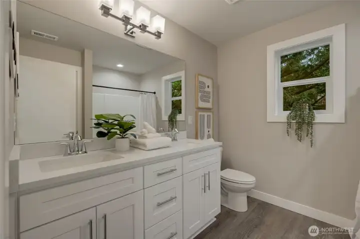 An upstairs full bathroom with dual sinks provides both comfort and efficiency, eliminating morning congestion while maintaining a sophisticated aesthetic.