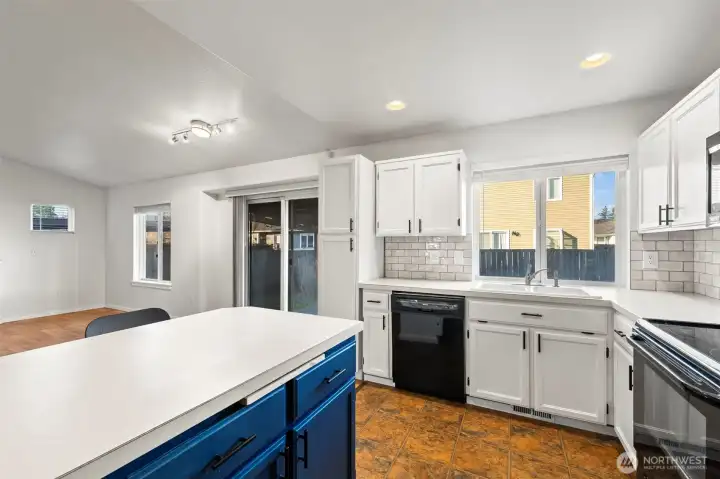 Kitchen with view of backyard including slider to the back