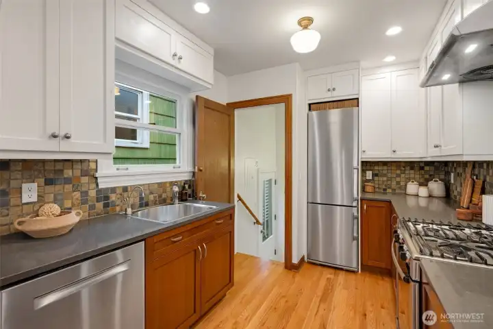 Updated kitchen with stainless steel appliances, quartz countertops & gas range