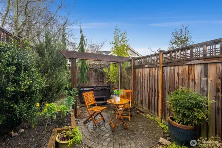 Enjoy your private rear patio with newer hot tub & mature shrubs