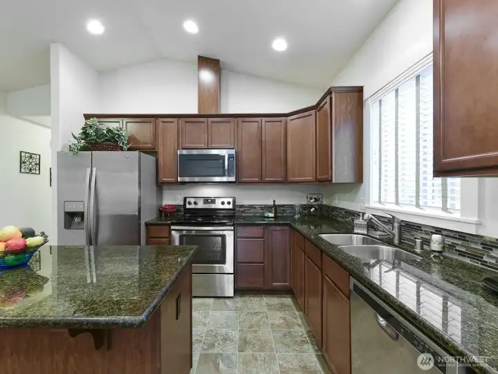All stainless appliances stay w/ sale. Tile backsplash.
