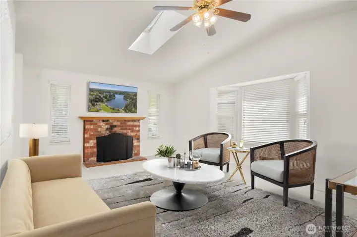 Virtually staged living room with plenty of natural light and vaulted ceiliings