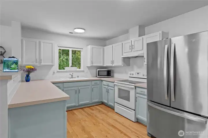 Kitchen with updated cabinets and appliances. Ready for new owners!