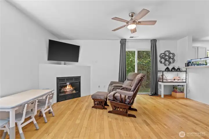 Living Room w/Gas Fireplace and Room for TV above. Sliding Glass Door to Back Patio allows plenty of light to enter. Private beautiful views abound!