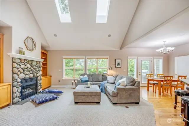 Living room is light and bright with skylights and vaulted ceilings.