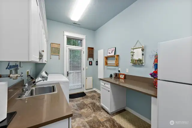 The utility room has access to the garage as well as a fully fenced dog run.