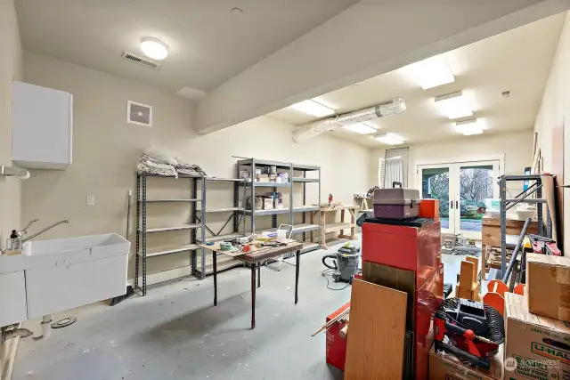 This shop area is adjacent to a large storage space. It is plumbed for an additional bathroom, so it could be converted into a separate living space.