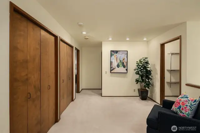 The upstairs landing has so much to meet the eye. It's a great place for a home office, library, or workout area. Plus, check out TONS of storage. From the closets on the left with shelves, to a huge walk in storage room shown to the right.