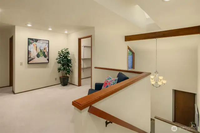 Another view of the upstairs landing with the storage room and space for a desk or library.