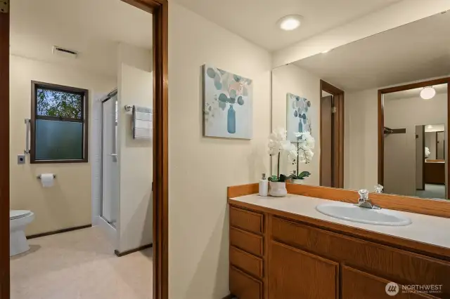 The ensuite bath has a separate shower area and sink, and then another sink where a second person can also get ready for the day.