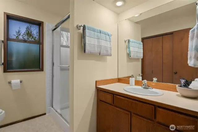 Inside the ensuite primary bath. There is also another sink to the right and separated by a door for privacy. Also notice the ample closet space.