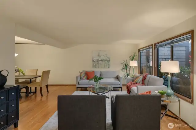 From the entry, you are greeted by the main living room and dining room beyond.