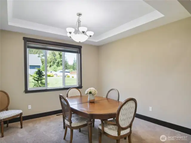 Formal dining room with decorative ceiling fininsh.