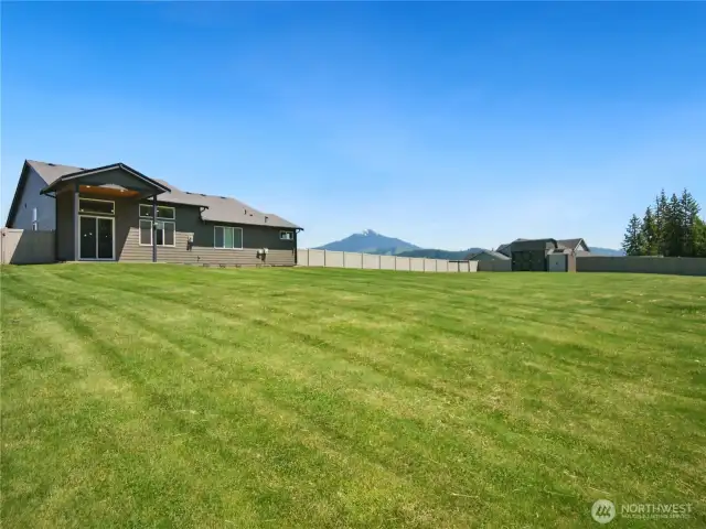This is the view from the back corner of the property. Note that beyond the fence in the back yard is green space. Storage sheds stay for extra storage room.