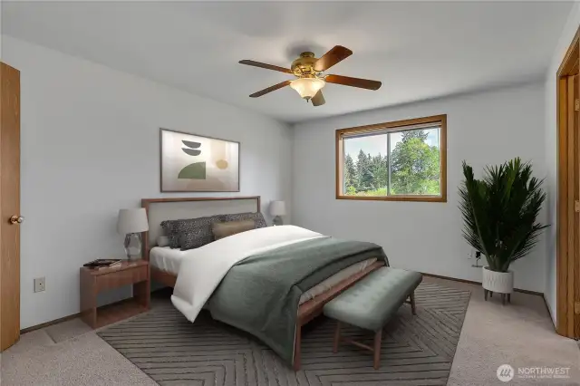 The primary suite faces the private backyard and features two walk-in closets, as well as its en-suite 5-piece bathroom. The ceiling fan offers nice cooling in the summer.