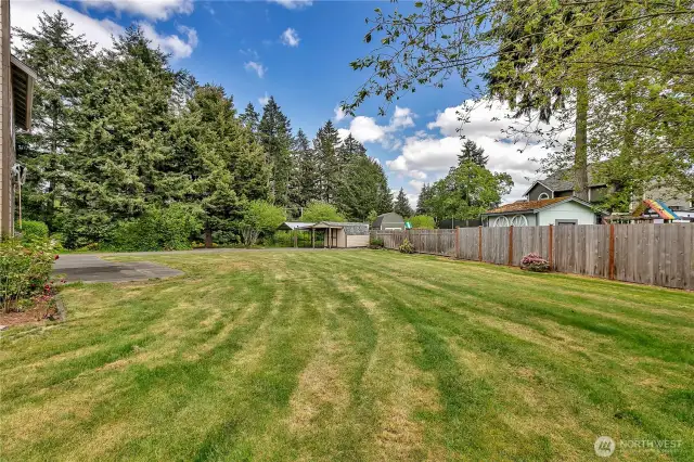Now that's a backyard! Look at all the space and privacy! In the corner, there are storage sheds and two carports.