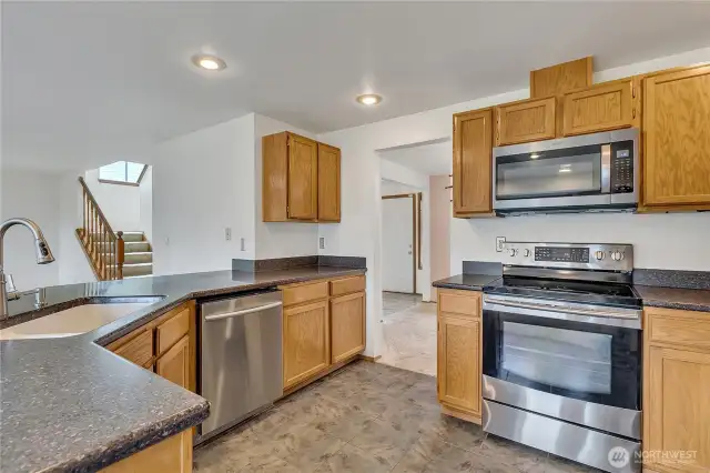 Here's another view of the kitchen with the microwave, range/oven and dishwasher. The breakfast bar is large and can sit at least six people very comfortably.