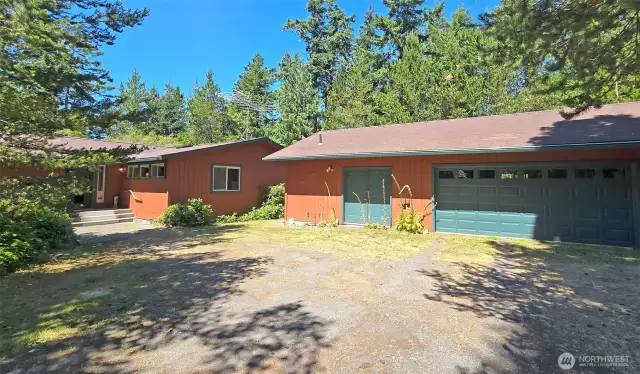 2 Car Garage with attached shop space and home entrance (to the left)