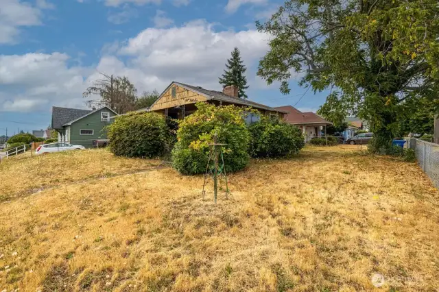 This large corner lot has so much potential. Grow your own vegetable garden or plant an english rose garden; the options are endless.