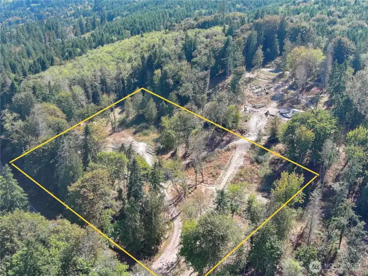 As you can see here, the driveway comes up and you have two building sites on either side of the road and the neighbor is up above with a buffer.