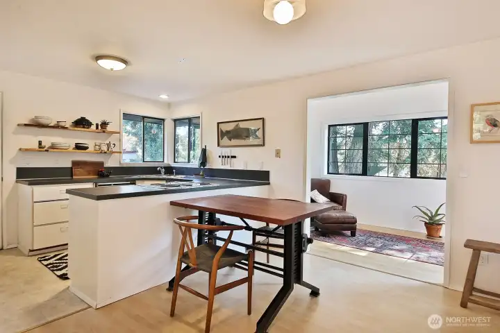 Sunroom is to the right with access to the back deck and the side (east) deck.