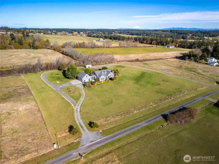 A gravel perimeter road encircles the property, along with a dedicated RV parking area at the rear. The RV pad has been fully excavated, filled, and compacted—perfect for a future pole barn. A curtain drain has been installed separately for improved drainage.