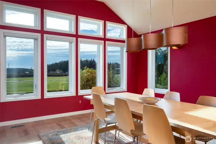 Spacious formal dining or music room highlighted by vaulted ceilings and expansive windows.